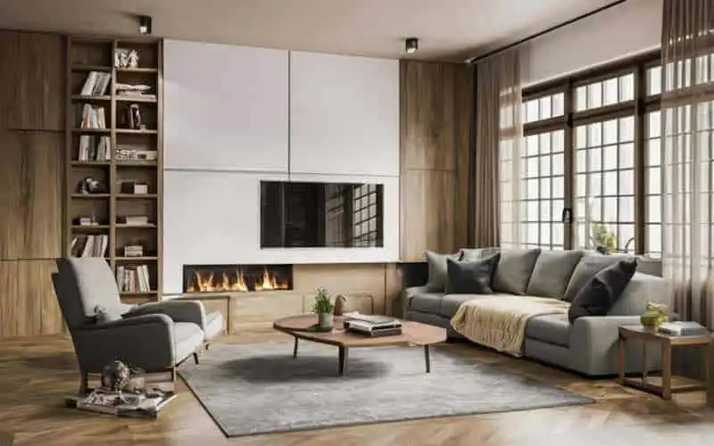 Stylish living room with fireplace, comfortable sofa, and large windows bringing in sunlight.