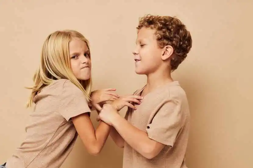 Young children arguing or fighting in a playful or serious manner.