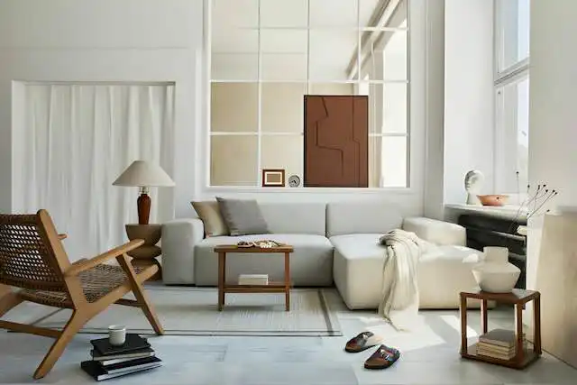 Bright contemporary living room with stylish furniture and large windows.