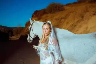Stunning bride with white horse outdoors.