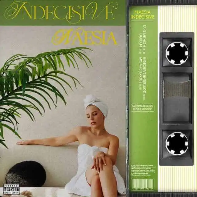 A woman relaxing after a spa session with towel and head wrap, surrounded by lush greenery.