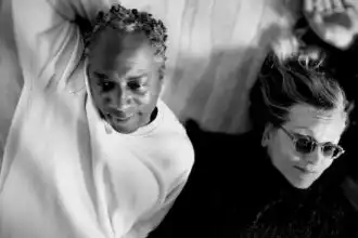 Close-up of two women lying together, showcasing friendship and acceptance.