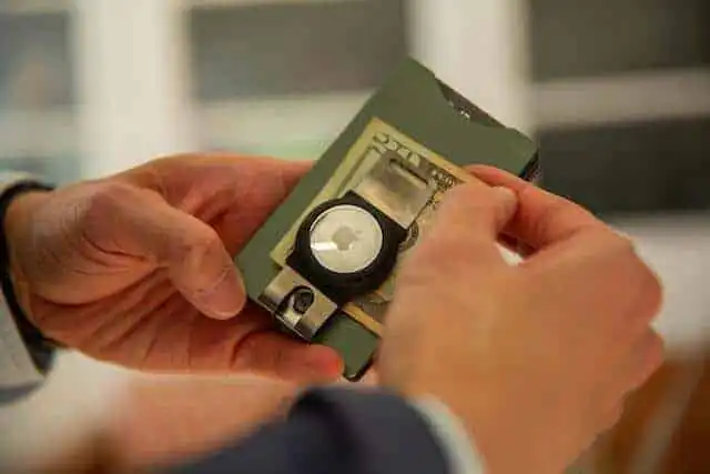 Hands exchanging paper cash and digital coins on currency and fintech theme.