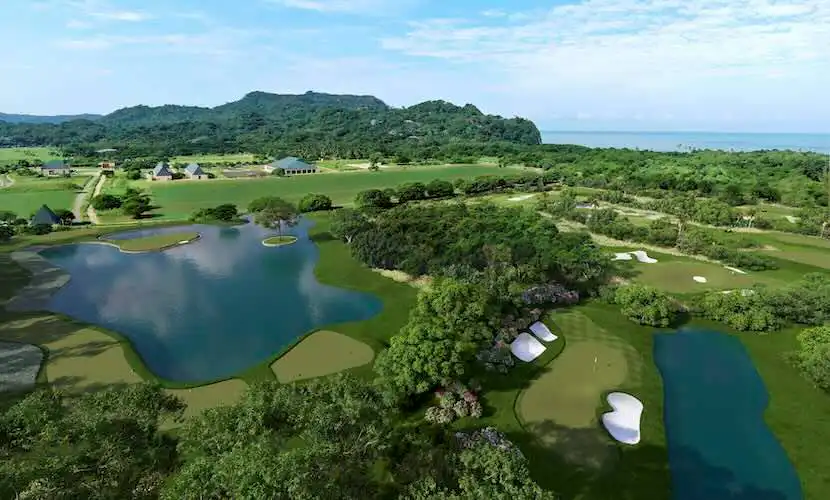 Scenic golf course with lakes and lush greenery near the coast, perfect for relaxation and outdoor activities.