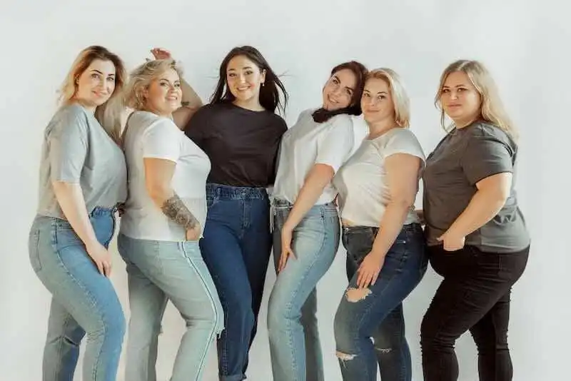 Women confidently posing together, celebrating body positivity and diversity in a supportive community.