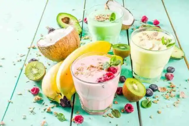 Bright and colorful fruit smoothies with berries, citrus, and greens.