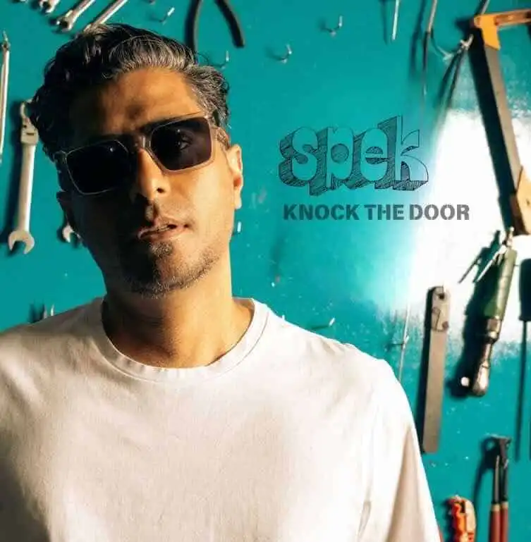 Man wearing sunglasses in workshop.