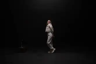 Happy woman dancing in minimalistic studio for LGBTQ+ and LGBTQ community.