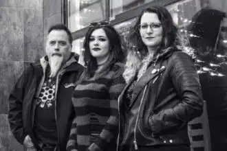 Edgy friends at Divine Magazine event in black-and-white style.