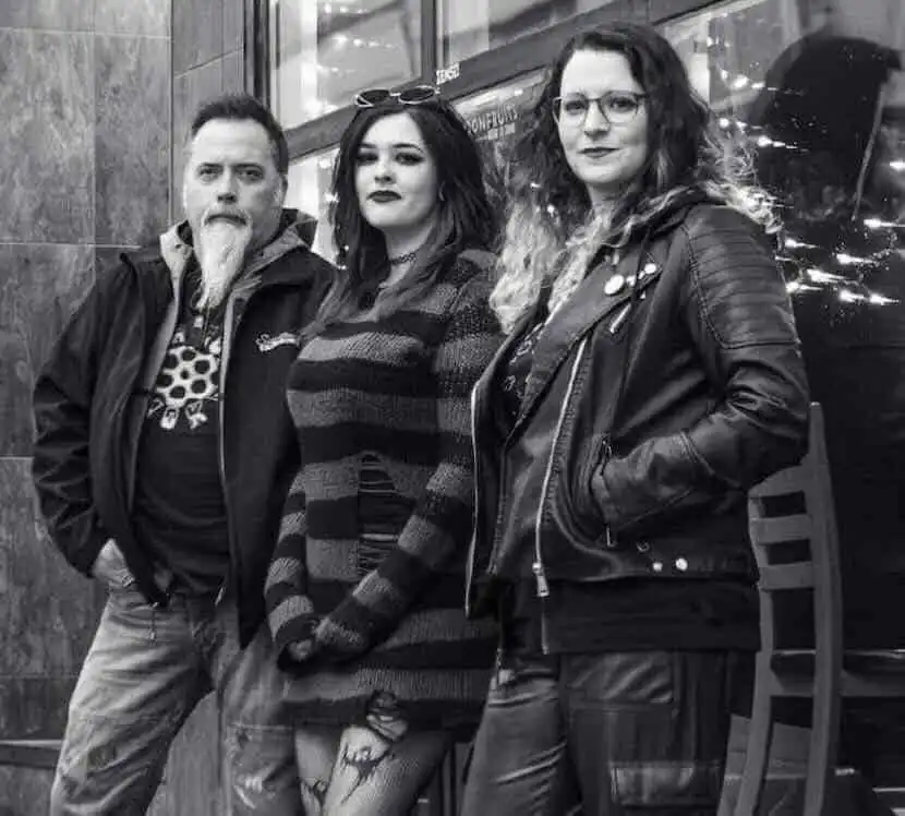 Edgy friends at Divine Magazine event in black-and-white style.