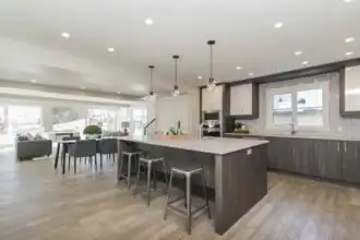 Spacious, contemporary kitchen with island, sleek cabinetry, and large windows for a bright, airy feel.