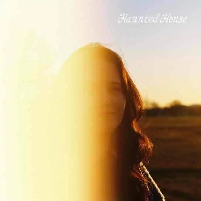 Woman standing outdoors at sunset, mysterious and spooky atmosphere for haunted house theme.