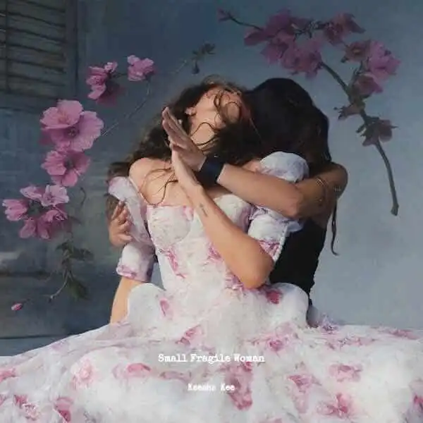 Two women hugging passionately, celebrating love and connection, with pink flowers in the background.