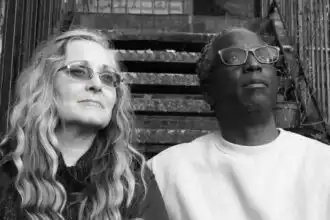 Elegant diverse couple with glasses outdoors.