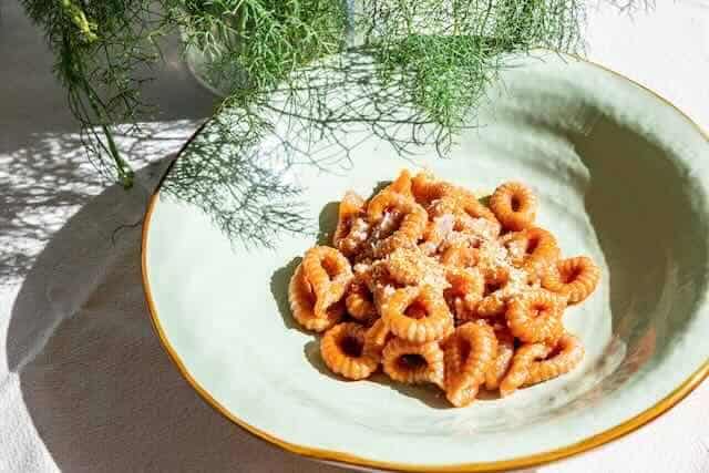 Delicious baked pasta served on a stylish plate with fresh herbs for garnish.