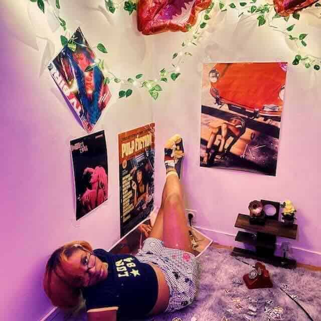 Bright room decorated with posters, balloons, and cozy rug, perfect for a trendy, artistic bedroom aesthetic.