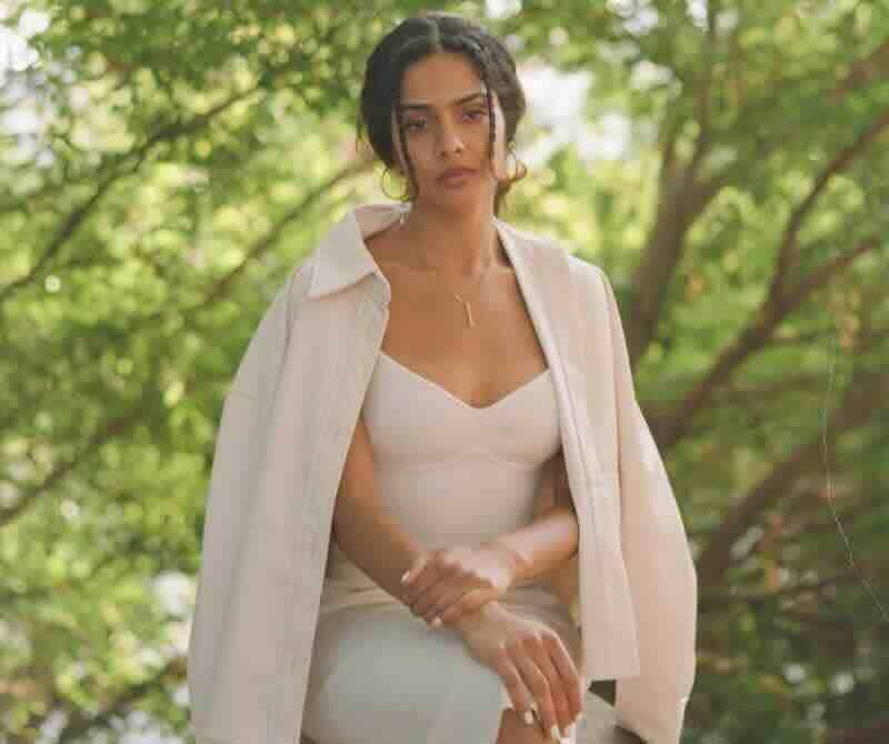 Beautiful woman posing in nature with lush green background.