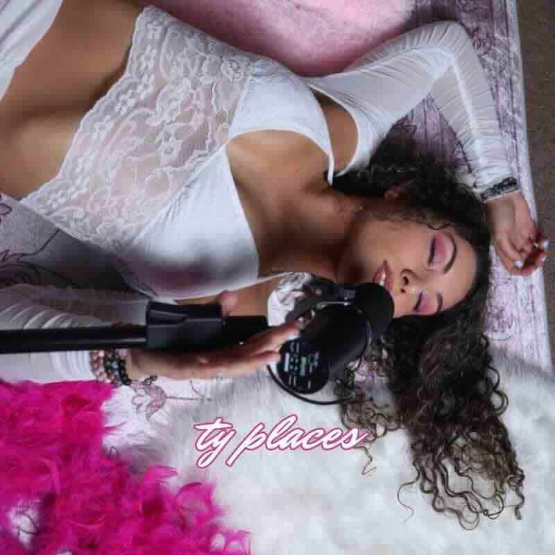 Beautiful woman singing in bed with microphone, relaxed and intimate mood.