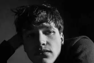 Stunning black-and-white portrait of a young man with captivating eyes, emphasizing mood and emotion. Perfect for fashion, portrait, or artistic photography.