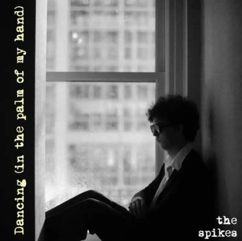 Silhouette of a man with glasses reading a book near a window, black and white photo.