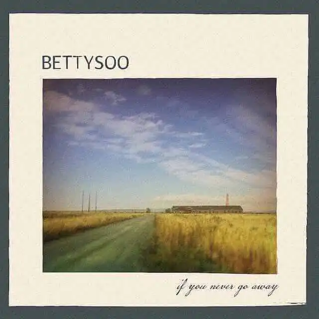 Scenic landscape with a dirt road, sky, and fields on the album cover of Bettysoo.