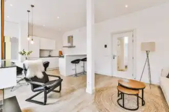 Bright, airy apartment with white walls, stylish furniture, and natural wood accents, ideal for modern living.