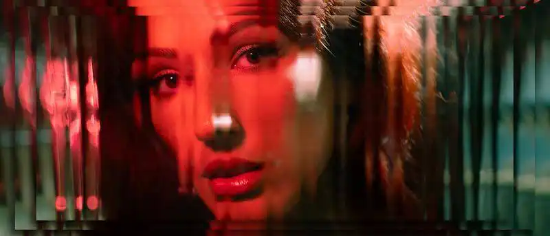 Close-up portrait of a woman with vibrant red lighting and urban glow effects.