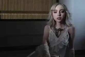 Young woman wearing a vintage lace dress with a statement necklace, soft lighting, modern interior background.