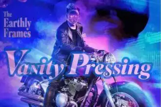 A person in leather jacket riding a motorcycle with vibrant neon lighting.