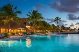 Stunning tropical resort pool with palm trees at sunset, perfect for relaxation and luxury vacations.