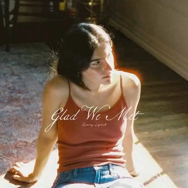Portrait of a woman sitting on a wooden floor, sunlight shining on her, with "Glad We Met" text, representing connection and relationships.