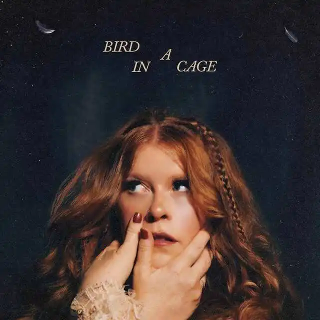Alt text: Portrait of a red-haired woman with thoughtful expression and braided hair, with the text "Bird in a Cage" floating above.