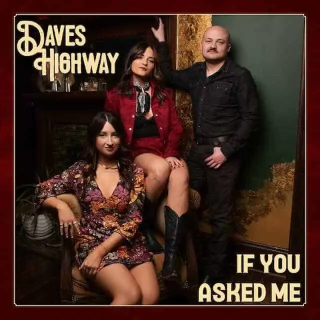 Bold band members posing indoors with vintage decor, promoting LGBTQ+ music scene.