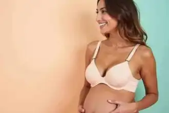 Beautiful woman smiling in a cream-colored nursing bra, promoting comfort and style for new mothers.
