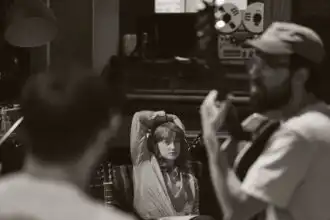 Young woman being interviewed in a recording studio.