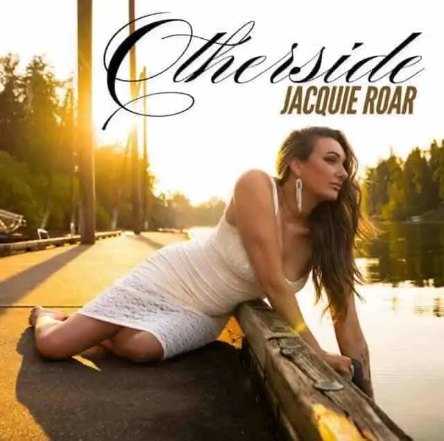 Beautiful woman relaxing near water at sunset.