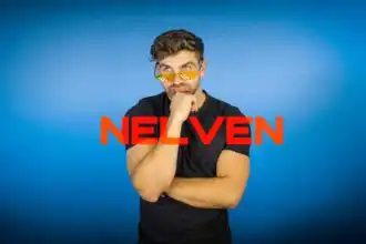 Man with stylish sunglasses and thoughtful expression, against a blue background, promoting LGBTQ+ pride and inclusivity.