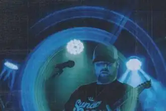 Music performance on stage with guitar, colorful blue lights, energetic atmosphere for fans.