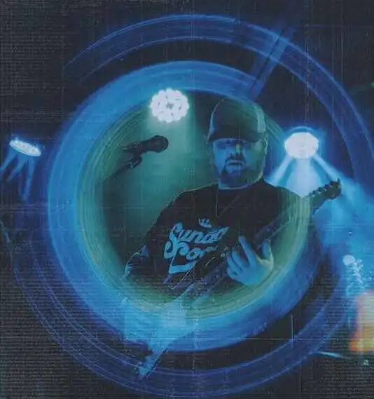 Music performance on stage with guitar, colorful blue lights, energetic atmosphere for fans.