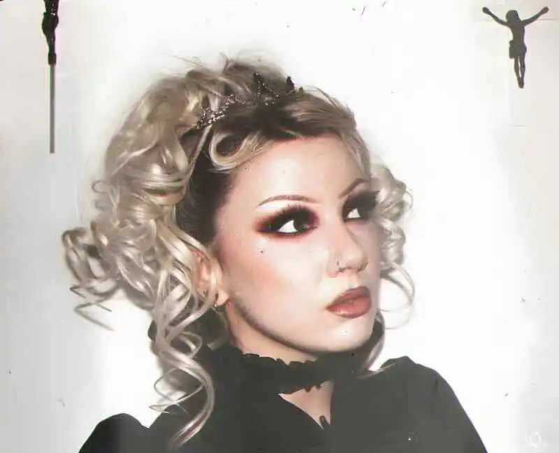 Gothic woman with platinum curly hair, bold makeup, and black lace choker for alternative fashion.