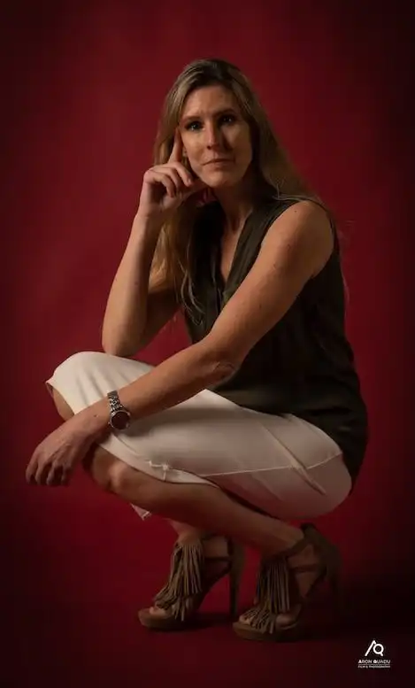 Thoughtful woman in stylish outfit posing for professional photography.