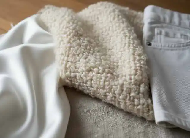 close up of natural fiber fabrics such as wool, silk, and cotton