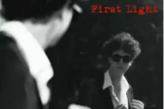 Black and white photo of a woman with sunglasses and an open shirt, engaging in a first light encounter.