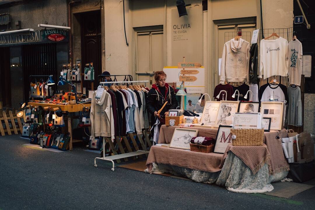a woman standing in front of a store selling clothing