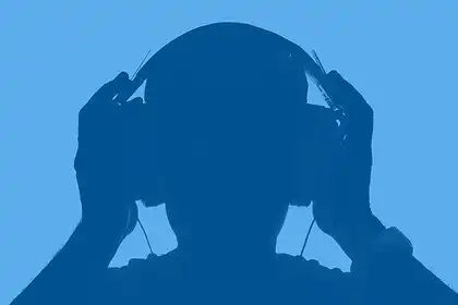 Headphones user enjoying music, silhouette of a person listening to audio.