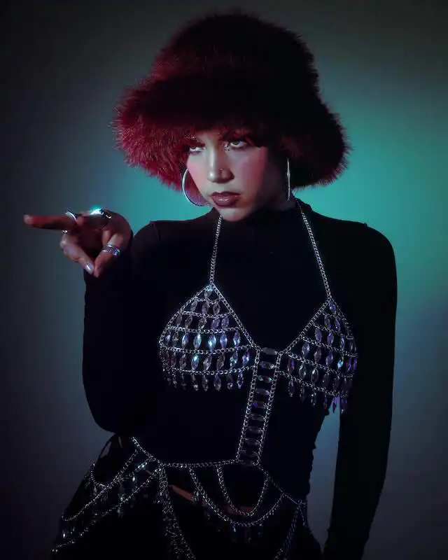 JULITH Unveils Her Powerful Debut EP “This Is A Kindness” JULITH wearing a furry hat and stylish jewelry, promoting her debut EP.