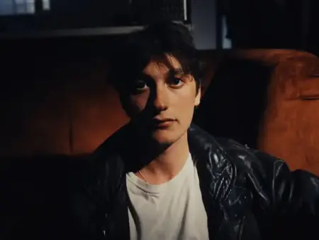 YONAH – Bird of Miracles | Debut Indie-Rock Album 2026 Portrait of YONAH, indie-rock artist, in a dark setting with leather jacket.