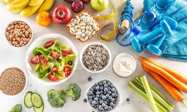 Colorful healthy food and workout accessories for fitness and nutrition.