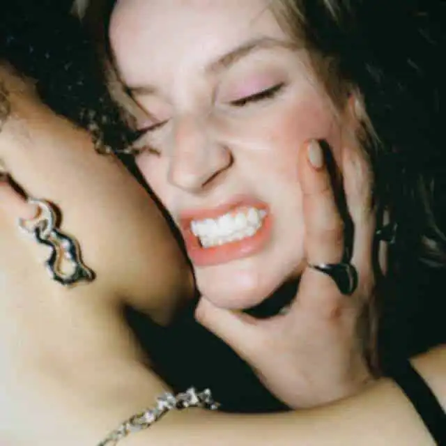 Close-up of passionate embrace between two women showing intimacy and affection.