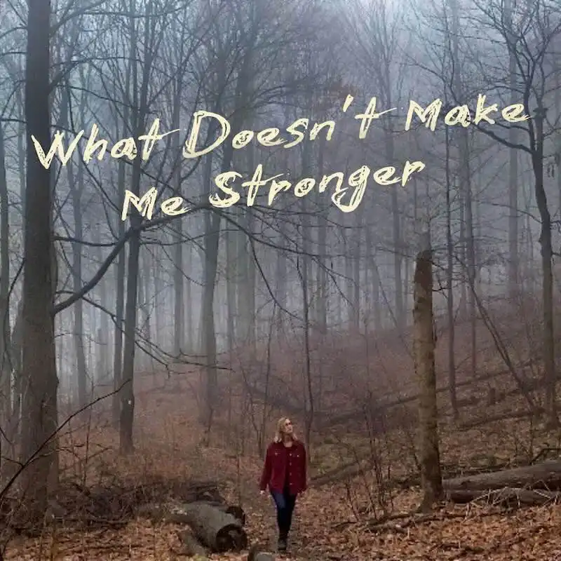 ALT: Woman walking in a misty forest with inspirational quote about inner strength.